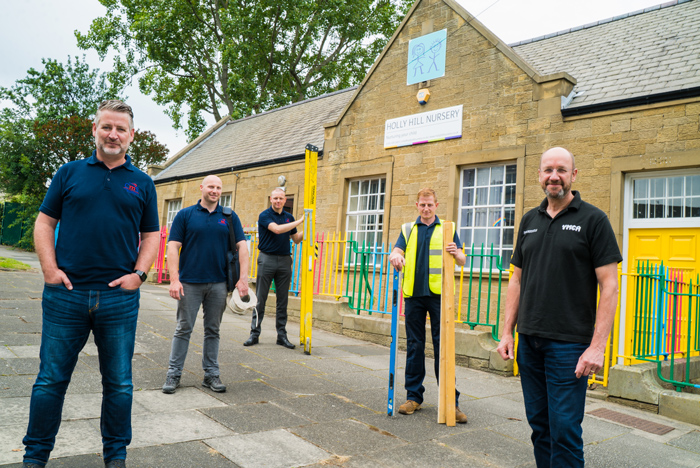 CMS compliance director Stephen Dunn (left) and YMCA Newcastle chief executive Jeff Hurst (right) pictured with members of the CMS team outside Holly Hill Nursery